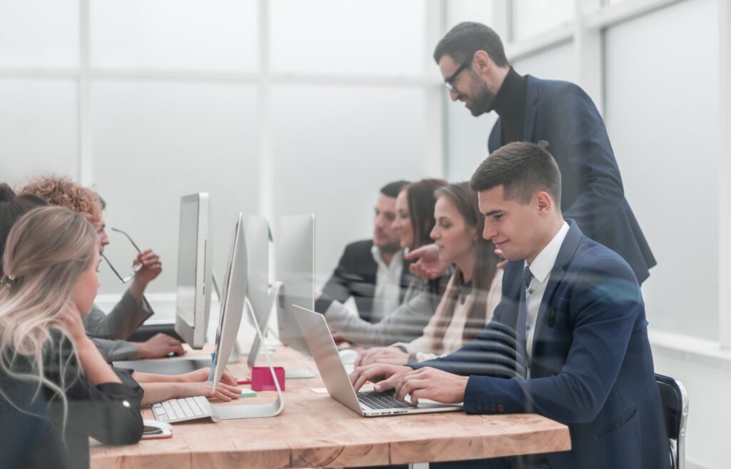 employees work on computers in a modern office